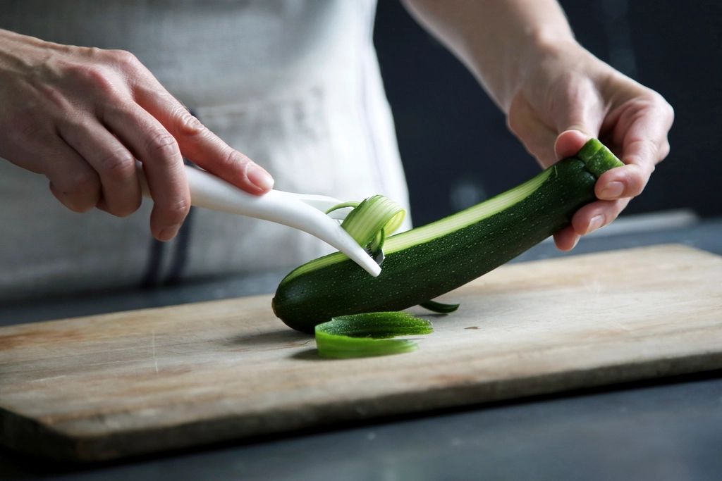 Preparing courgette on a wooden board